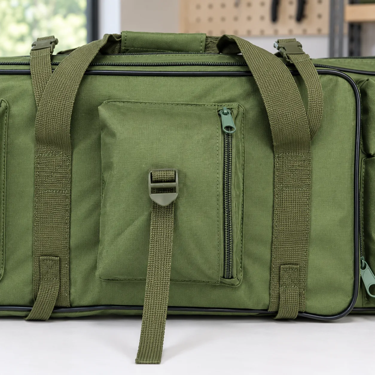 Front pocket zipper, adjuster and green webbing detail