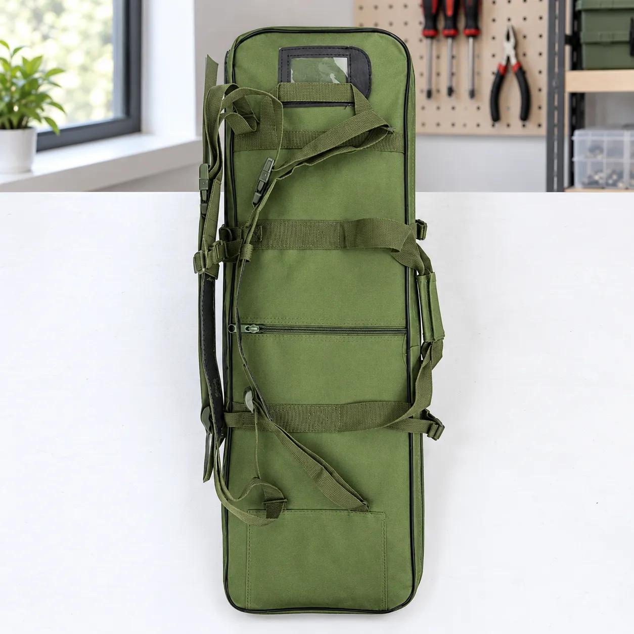 Rear backpack straps and identification window of compact green bag