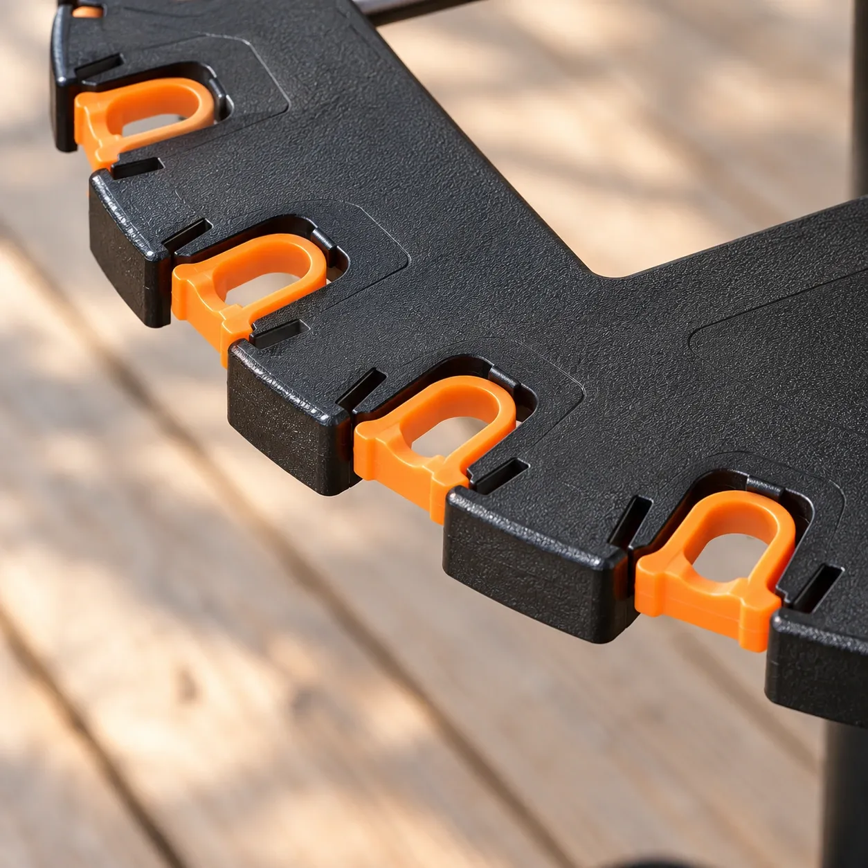 Soren Rotating Rod Rack - Black — orange clip seating and molded rim close view